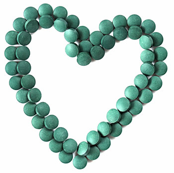 Bio super chlorella tabletten neergelegd in de vorm van een hartje Bio super chlorella tabletten neergelegd in de vorm van een hartje